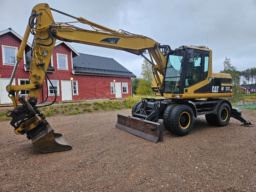 Hjulgrävare Caterpillar M312 Tiltrotator Redskap